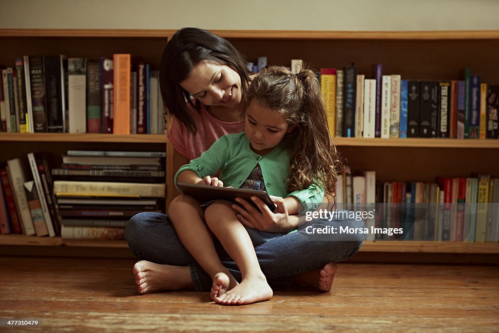 Mother and daughter with digital tablet