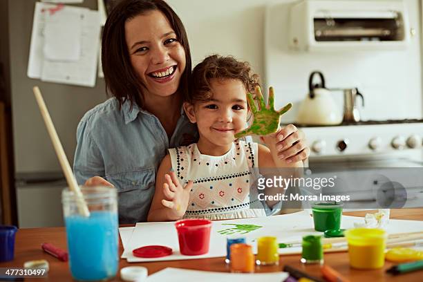 portrait of mother and daughter painting - colorful home interior stock pictures, royalty-free photos & images