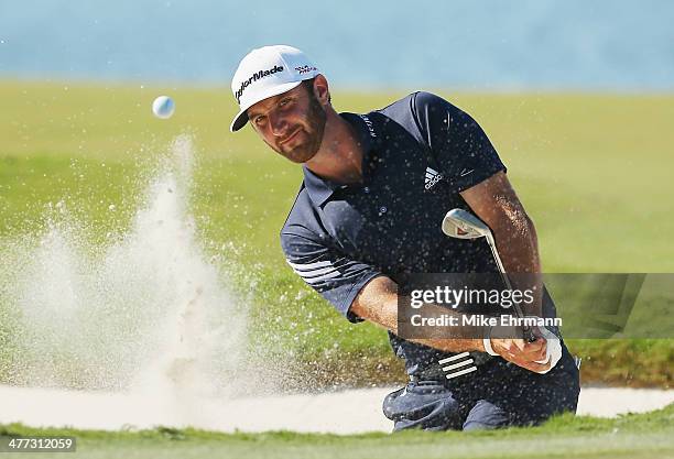 Dustin Johnson plays a bunker shot on the eighth hole during the third round of the World Golf Championships-Cadillac Championship at Trump National...