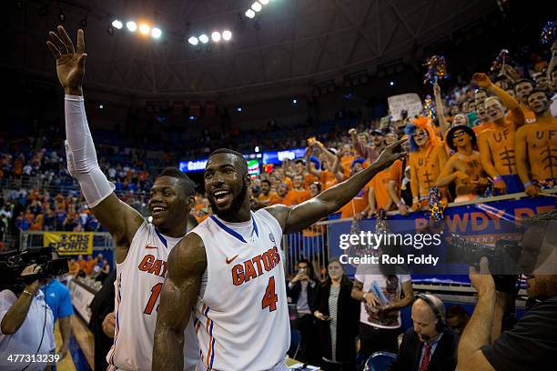 Will Yeguete and Patric Young of the Florida Gators lead the crowd in singing "happy birthday" to Michael Frazier II , after the game against the...