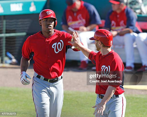 Destin Hood is congratulated by Mike Fontenot of the Washington Nationals after hitting a three run home run in the eighth inning against the St...