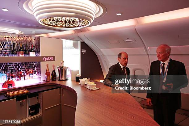 Akbar Al Baker, chief executive officer of Qatar Airways Ltd., left, and Timothy "Tim" Clark, inspect the First Class bar area during a tour of an...
