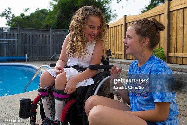 Alessia Commisso left, and Weronika Rodowicz, 13 share a joke in the Commisso family back yard. Sonia Commisso the mother of Alessia, 12 is...