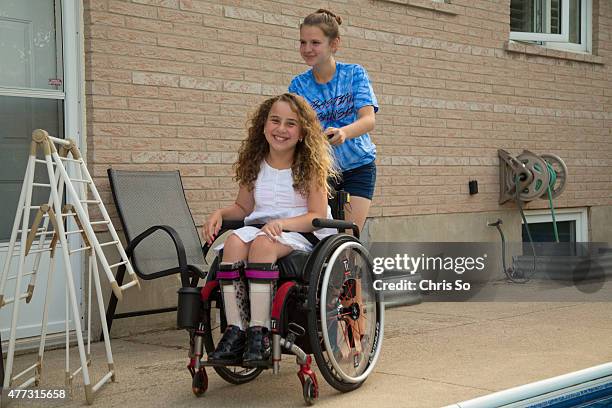 Alessia Commisso left, is being pushed by her friend Weronika Rodowicz, 13 in the Commisso family back yard. Sonia Commisso the mother of Alessia, 12...