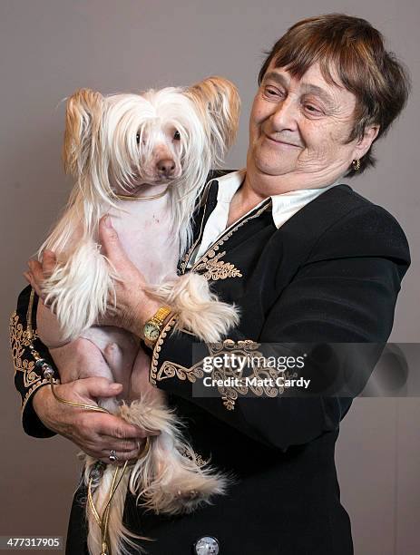 Shiela Bruty from Dorset poses with her dog, Herbie, a Chinese Crested hairless, during the Toy and Utility day of the Crufts dog show at the NEC on...