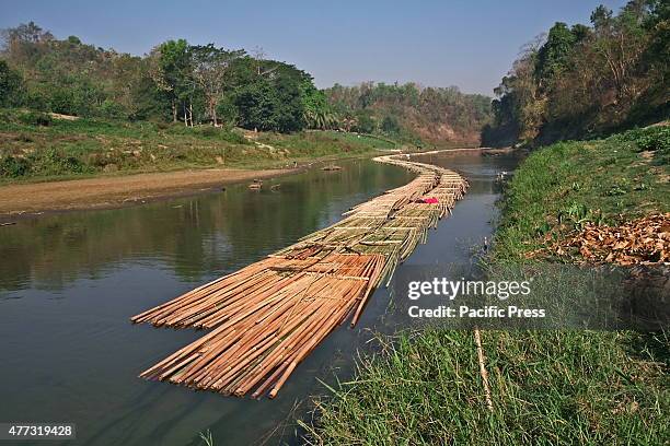 Group of local people are bamboo rafting on the Matamuhuri River into the Bandarban hill. Bamboo is highly in demand in Bangladesh for various home...