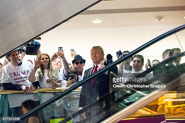Business mogul Donald Trump rides an escalator to a press event to announce his candidacy for the U.S. Presidency at Trump Tower on June 16, 2015 in...