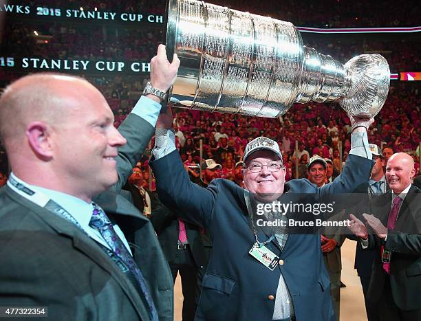 Stan Bowman and his father Scotty Bowman of the Chicago Blackhawks celebrate after defeating the Tampa Bay Lightning by a score of 2-0 in Game Six to...