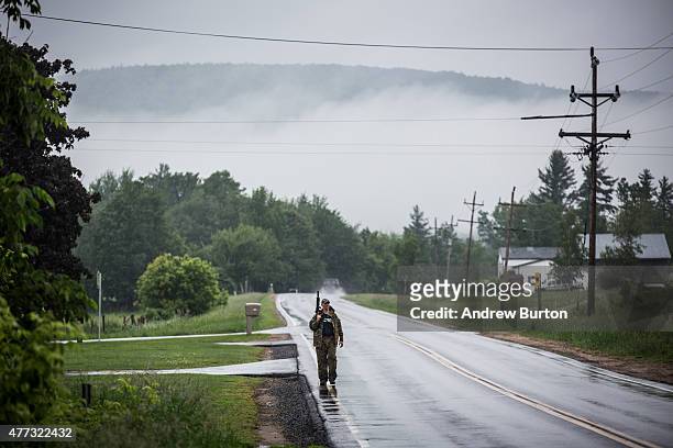 Task force of U.S. Marshalls and police officers go door to door searching for two escaped convicts on June 16, 2015 outside Dannemora, New York. The...