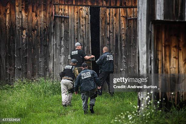 Task force of U.S. Marshalls and police officers go door to door searching for two escaped convicts on June 16, 2015 outside Dannemora, New York. The...