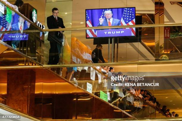 Real estate mogul Donald Trump is seen on a monitor as he announces his bid for the presidency in the 2016 presidential race during an event at the...