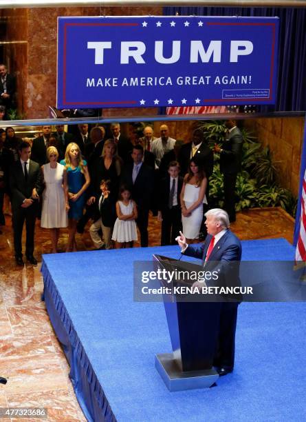 Real estate mogul Donald Trump announces his bid for the presidency in the 2016 presidential race as his family looks on, during an event at the...