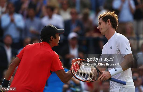 Andy Murray of Great Britain shakes hands with Yen-Hsun Lu of Chinese Taipei after their men's singles first round match during day two of the Aegon...