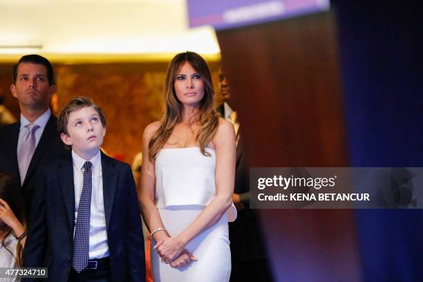 Melania Trump and family listen as her husband real estate investor Donald Trump makes his announcement that he will run for the 2016 presidential...