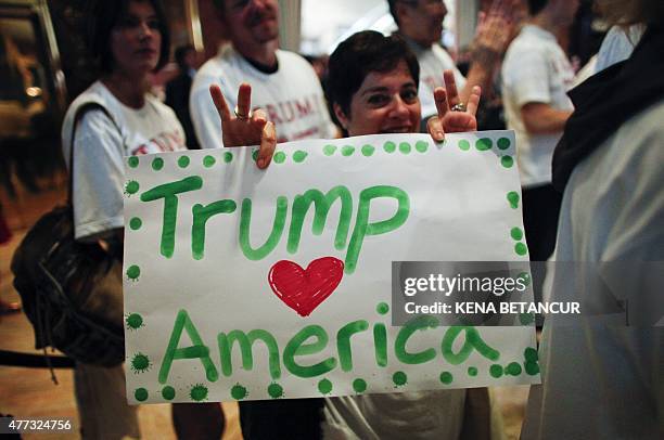 Follower of real estate investor Donald Trump holds a sign as he makes his announcement that he will run for the 2016 presidential elections at the...