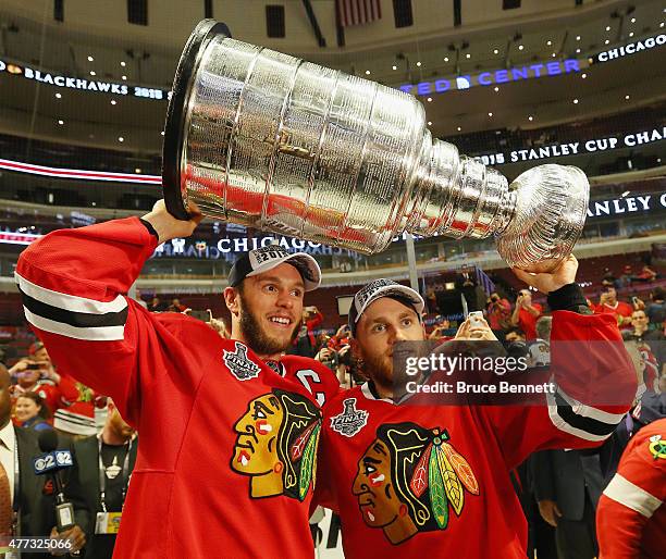 Jonathan Toews and Patrick Kane of the Chicago Blackhawks celebrate by hoisting the Stanley Cup after defeating the Tampa Bay Lightning by a score of...