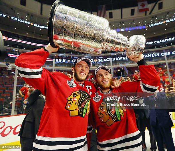 Jonathan Toews and Patrick Kane of the Chicago Blackhawks celebrate by hoisting the Stanley Cup after defeating the Tampa Bay Lightning by a score of...