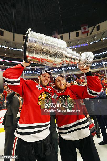 Jonathan Toews and Patrick Kane of the Chicago Blackhawks celebrate by hoisting the Stanley Cup after defeating the Tampa Bay Lightning by a score of...