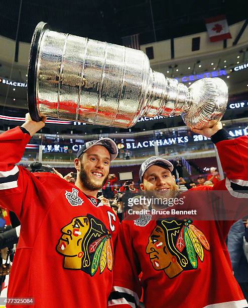 Jonathan Toews and Patrick Kane of the Chicago Blackhawks celebrate by hoisting the Stanley Cup after defeating the Tampa Bay Lightning by a score of...