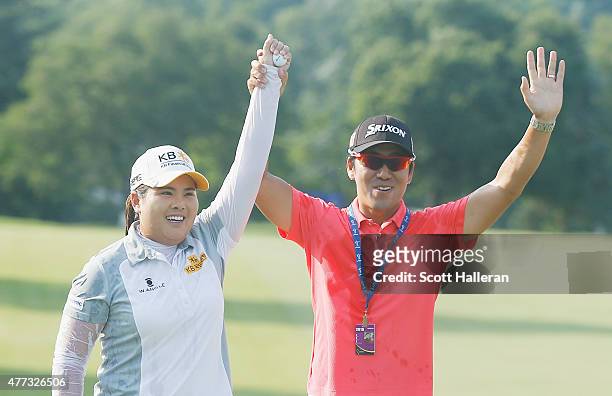 Inbee Park of South Korea celebrates on the 18th green with her husband Gi Hyeob Nam after her five-stroke victory at the KPMG Women's PGA...