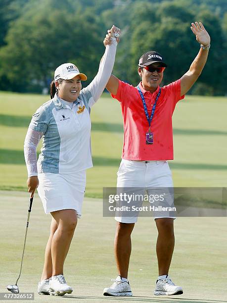 Inbee Park of South Korea celebrates on the 18th green with her husband Gi Hyeob Nam after her five-stroke victory at the KPMG Women's PGA...