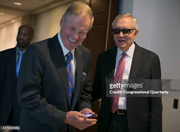 Sen. Bill Nelson, D-Fla., left, who was speaking with President Obama on his phone, laughs as Senate Minority Leader Harry Reid, D-Nev., hung up on...