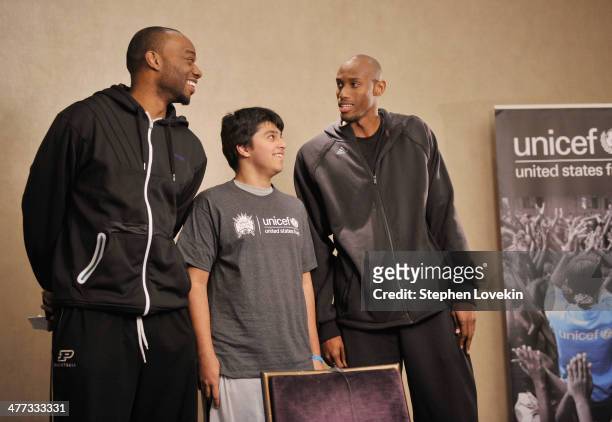 Athletes Carl Landry and Travis Outlaw record a PSA with a student from The United Nations International School at an event recognizing New York City...