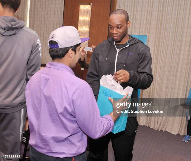 Athlete Carl Landry of The Sacramento Kings and a student from The United Nations International School attend an event recognizing New York City...