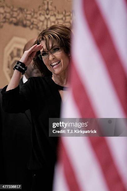 Conservative pundit, television personality and former vice presidential candidate Sarah Palin gives a salute as she leaves the stage during the 41st...