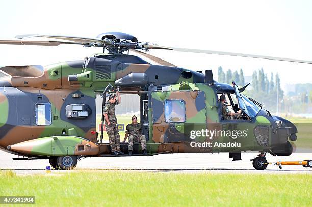 An army helicopter prepares for an aerial display as crew members sit during the 51st international Paris Air Show at Le Bourget, near Paris, France...