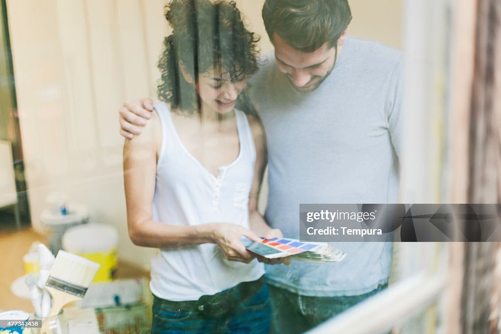 Young couple painting their new apartment.