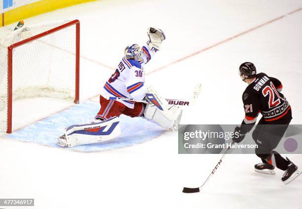 Henrik Lundqvist of the New York Rangers stops a point-blank shot by Drayson Bowman of the Carolina Hurricanes during their game at PNC Arena on...