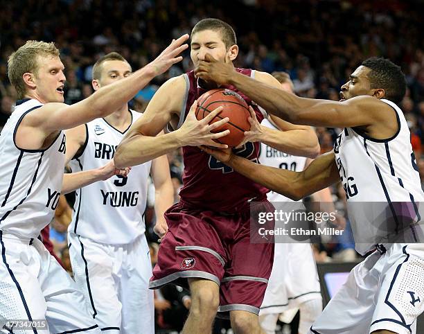 Marin Mornar of the Loyola Marymount Lions and Tyler Haws and Anson Winder of the Brigham Young Cougars go after a loose ball during a quarterfinal...