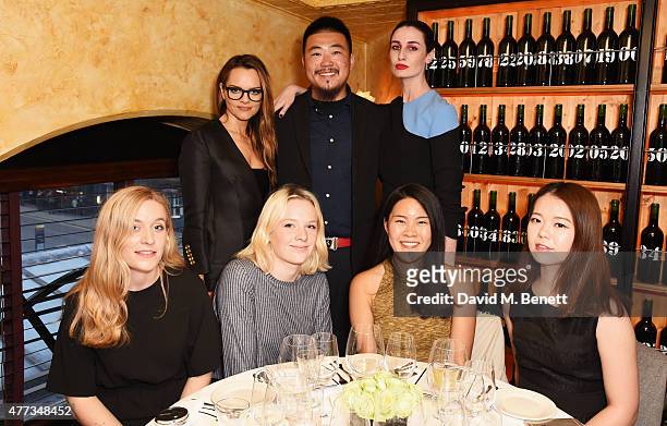 Maria Hatzistefanis and Erin O'Connor pose with Central Saint Martins students at a dinner hosted by Maria Hatzistefanis to launch the Rodial Design...