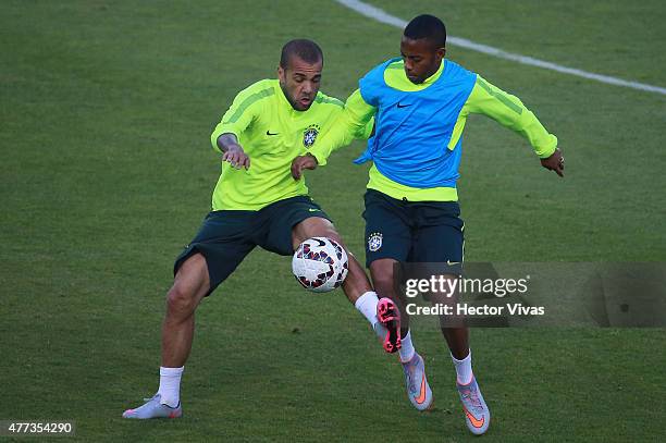 Dani Alves of Brazil fights for the ball with Robinho during a training session at Monumental Stadium on June 16, 2015 in Santiago, Chile. Brazil...