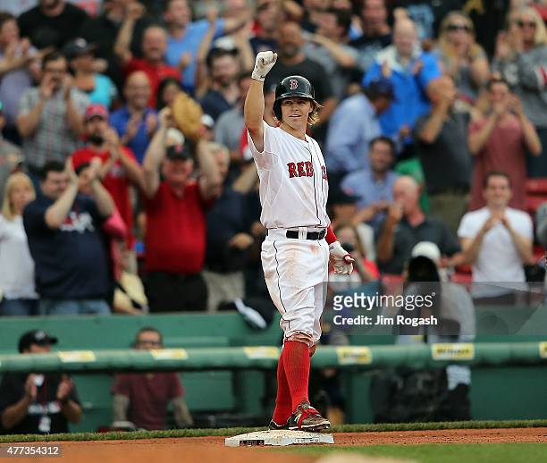 Brock Holt of the Boston Red Sox reacts after hitting a triple to give him the cycle in the eighth inning against the Atlanta Braves at Fenway Park...