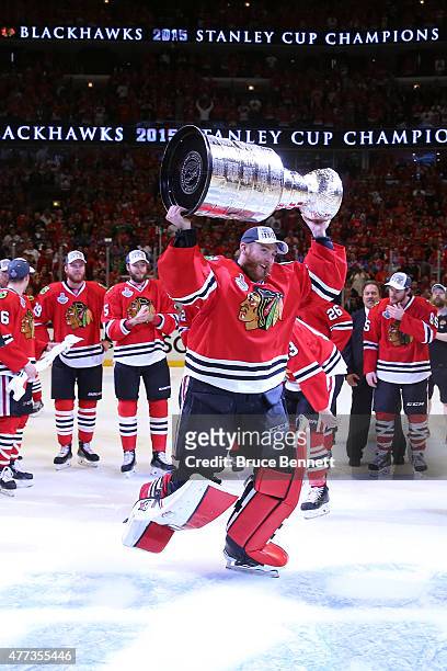 Scott Darling of the Chicago Blackhawks celebrates with the Stanley Cup after defeating the Tampa Bay Lightning by a score of 2-0 in Game Six to win...