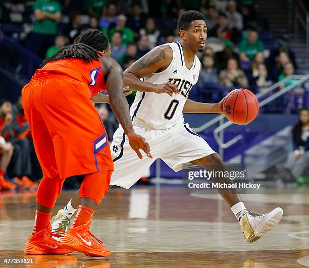 Eric Atkins of the Notre Dame Fighting Irish dribbles the ball against Rod Hall of the Clemson Tigers at Purcel Pavilion on February 11, 2014 in...