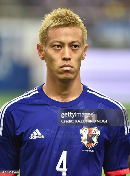 Japan's national football team midfielder Keisuke Honda poses prior to the second round Group E 2018 World Cup Asian qualifier football match against...