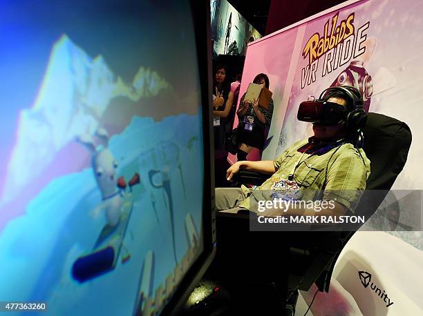 Gamer experiences the virtual reality "Rabbids" game simulator at the Ubisoft display at the opening day of the Electronic Entertainment Expo, known...