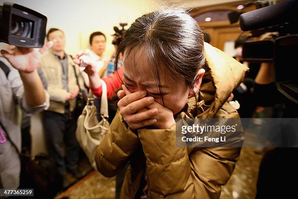 Relative of a passenger onboard Malaysia Airlines flight MH370 cries out at a local hotel where families are gathered on March 9, 2014 in Beijing,...