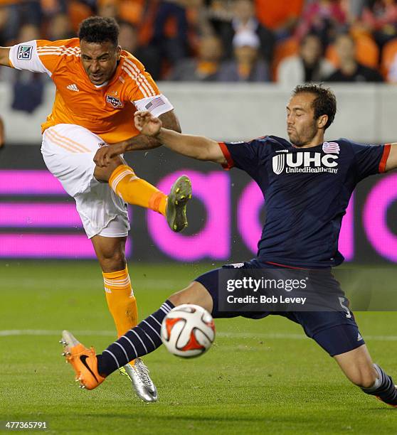 Giles Barnes of Houston Dynamo shoots on goal past A.J. Soares of New England Revolution at BBVA Compass Stadium on March 8, 2014 in Houston, Texas.