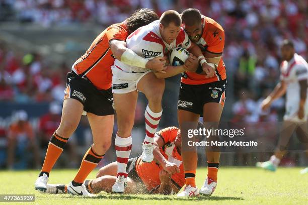 Trent Merrin of the Dragons is tackled during the round one NRL match between the St George Illawarra Dragons and the Wests Tigers at ANZ Stadium on...