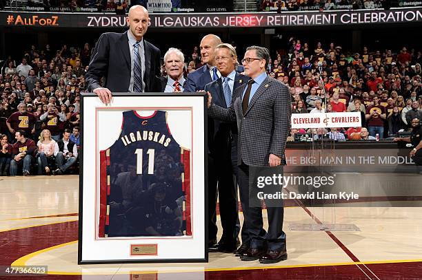 Zydrunas Ilgauskas of the Cleveland Cavaliers receives a framed jersey during halftime of the game against the New York Knicks at The Quicken Loans...