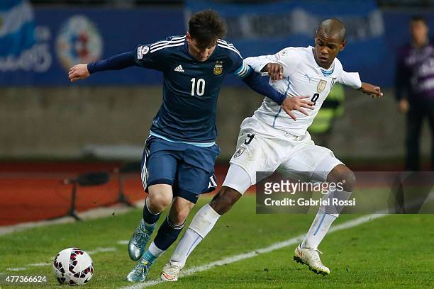 Lionel Messi of Argentina fights for the ball with Diego Rolan of Uruguay during the 2015 Copa America Chile Group B match between Argentina and...