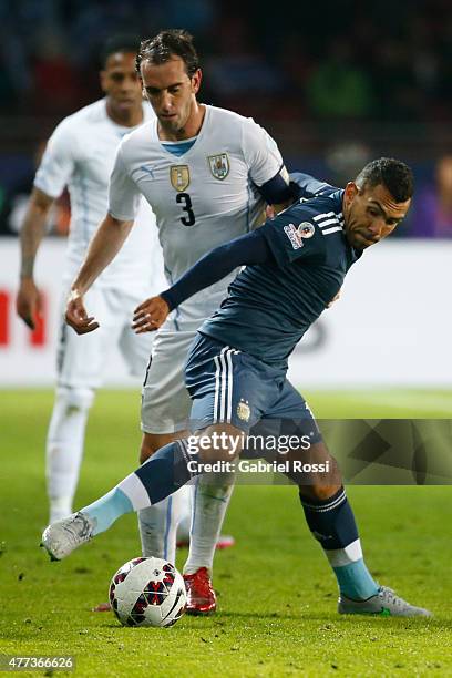 Carlos Tevez of Argentina fights for the ball with Diego Godin of Uruguay during the 2015 Copa America Chile Group B match between Argentina and...