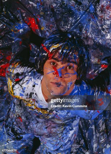 Singer Ian Brown of the Stone Roses, covered in paint during a photoshoot, 5th November 1989.