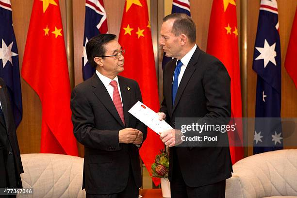 Australian Prime Minister Tony Abbott meets with China's Minister of Commerce Gao Hucheng at Parliament House on June 17, 2015 in Canberra,...