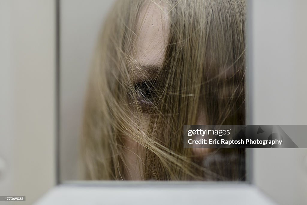 Teenage peering through security window