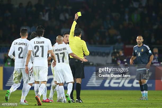 Referee Sandro Ricci shows a yellow card to Javier Mascherano of Argentina during the 2015 Copa America Chile Group B match between Argentina and...
